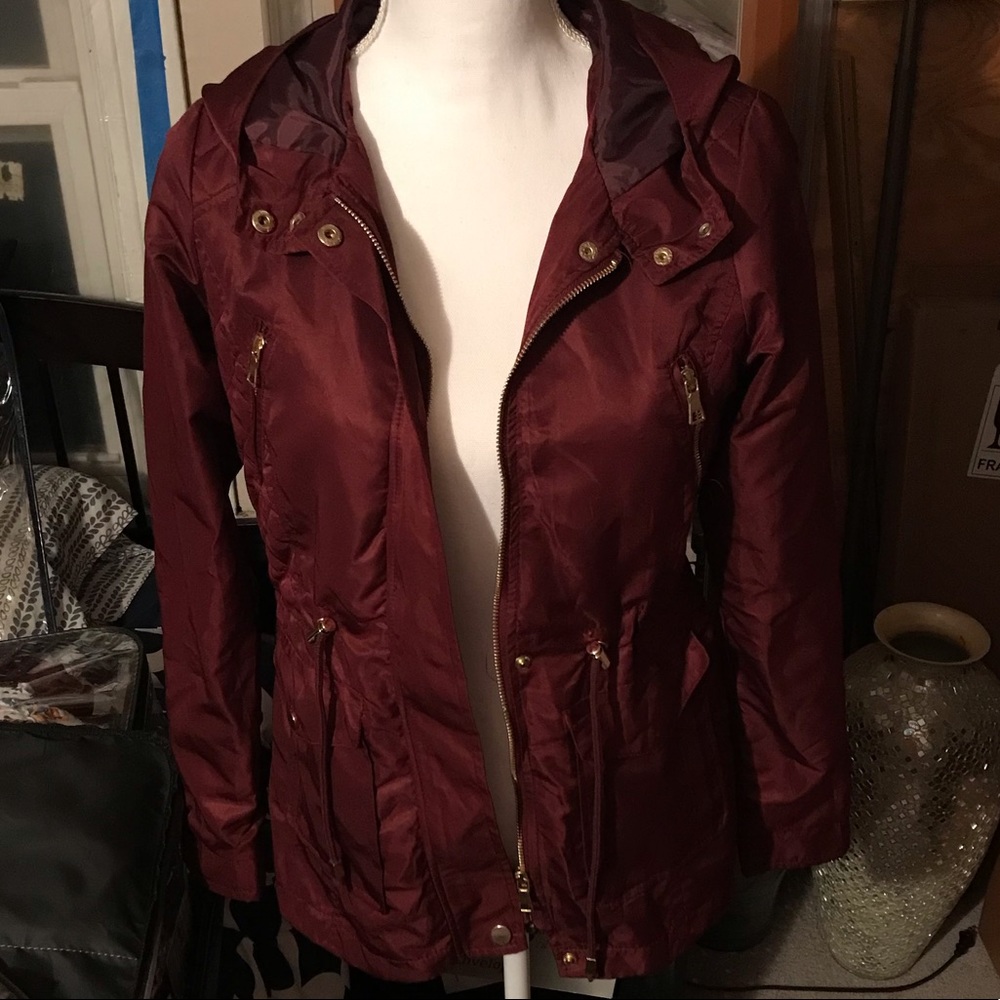 Thin jacket , fits for a sweater underneath has strings to make it tighter